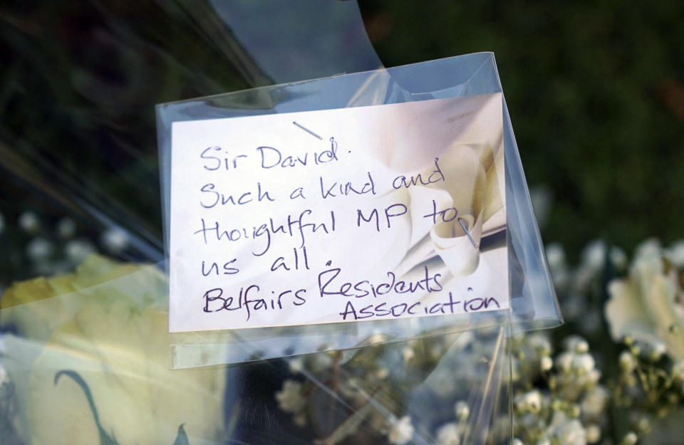 Flowers are laid near the Belfairs Methodist Church in Eastwood Road North, where Conservative MP Sir David Amess was stabbed several times at a constituency surgery, in Leigh-on-Sea, Essex, England, Friday, Oct. 15, 2021. British Conservative lawmaker David Amess has died after being stabbed Friday during a meeting with constituents at a church in eastern England. A 25-year-old man has been arrested. (Yui Mok/PA via AP)