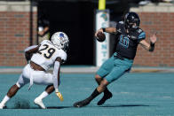 Coastal Carolina quarterback Grayson McCall (10) scrambles as Appalachian State's Brendan Harrington pursues during the first half of an NCAA college football game, Saturday, Nov. 21, 2020, in Conway, S.C. (AP Photo/Richard Shiro)