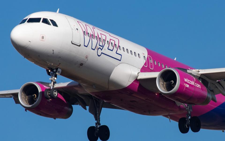 Airbus A320 ( A320-232) aircraft of the low cost airline Wizz Air ( W6 ) with registration landing at Eindhoven EIN EHEH international airport in The Netherlands during the day with nice weather and blue sky. WizzAir is a budget European airline with headquarters in Budapest, Hungary. (Photo by Nicolas Economou/NurPhoto via Getty Images) - Nicolas Economou/NurPhoto via Getty Images