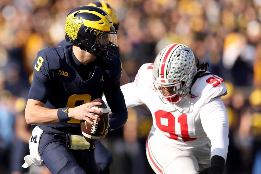 ANN ARBOR, MICHIGAN – NOVEMBER 25: J.J. McCarthy #9 of the Michigan Wolverines scrambles against the Ohio State Buckeyes during the first quarter in the game at Michigan Stadium on November 25, 2023 in Ann Arbor, Michigan. (Photo by Ezra Shaw/Getty Images)