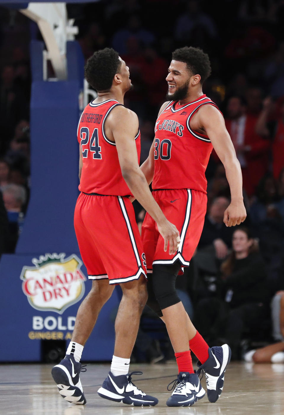 St. John's guard LJ Figueroa (30) celebrates with guard Nick Rutherford (24) during the second half of the team's NCAA college basketball game against Georgetown in the first round of the Big East men's tournament Wednesday, March 11, 2020, in New York. (AP Photo/Kathy Willens)