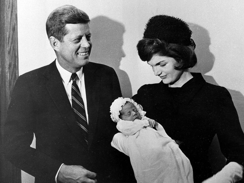 John F. Kennedy and Jacqueline Kennedy pose at Georgetown University Hospital in Washington Dec. 8, 1960, with their son, John F. Kennedy Jr., following his baptism.