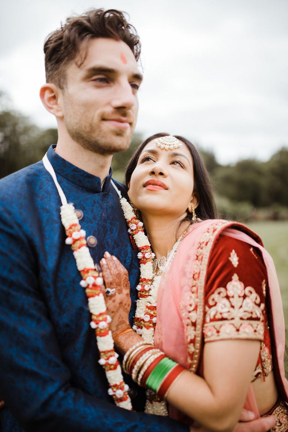 Alastair Spray and Angie Tiwari posing for photographs on their wedding day.