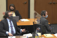 In this image from video, defense attorney Eric Nelson, left, Nelson's assistant Amy Voss, back, and former Minneapolis police officer Derek Chauvin, right, participate in a sidebar through headsets with Hennepin County Judge Peter Cahill as he presides Monday, March 29, 2021, in the trial of Chauvin, in the May 25, 2020, death of George Floyd at the Hennepin County Courthouse in Minneapolis, Minn. (Court TV via AP, Pool)