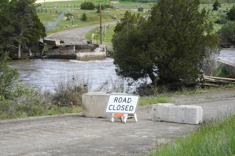 The Yellowstone River flows past a washed out bridge Wednesday, June 15, 2022, near Gardiner, Mont. Yellowstone National Park officials say more than 10,000 visitors have been ordered out of the nation's oldest national park after unprecedented flooding tore through its northern half, washing out bridges and roads and sweeping an employee bunkhouse miles downstream. (AP Photo/Rick Bowmer)