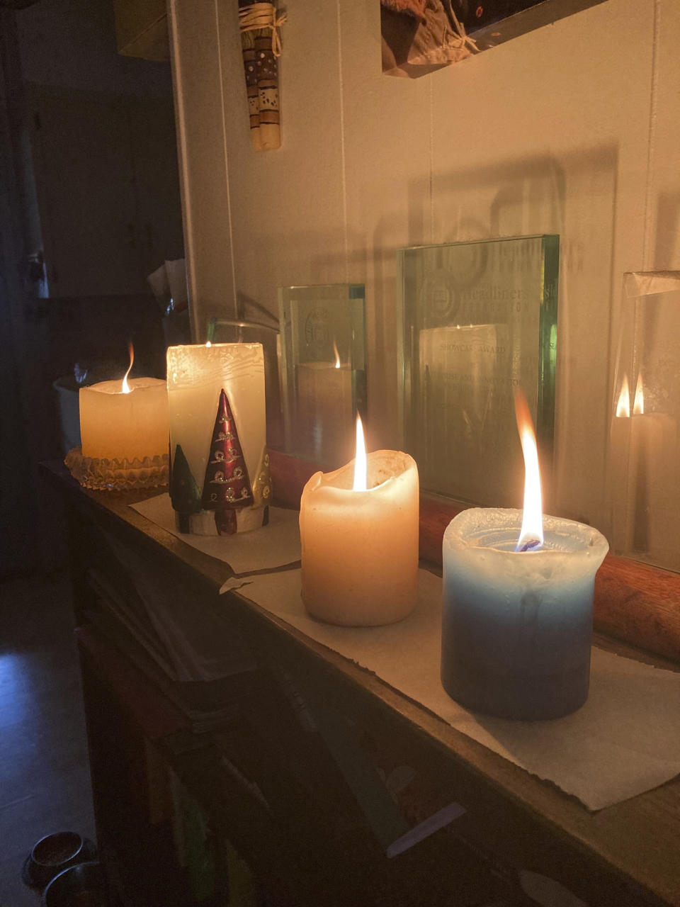 Candles are lit at an Austin, Texas, home, Wednesday, Feb. 1, 2023. A storm knocked out power for a third of the city. Even as temperatures finally pushed above freezing in Austin — and were expected to climb past 50 degrees (10 Celsius) on Friday — the relief will be just in time for an Arctic front to drop from Canada and threaten northern states. (Andrea Ball/Houston Chronicle via AP)