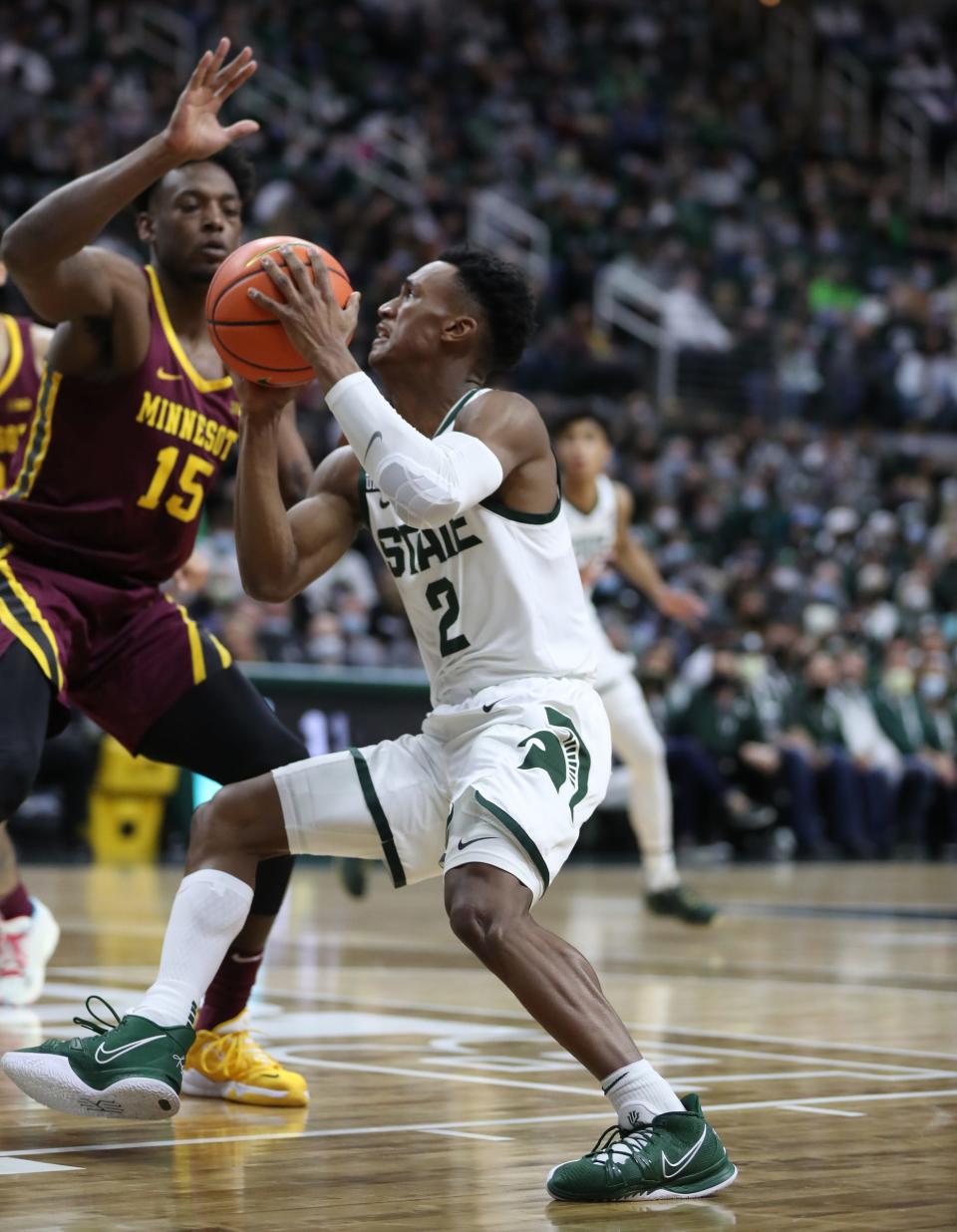 Michigan State Spartans guard Tyson Walker (2) drives against Minnesota Golden Gophers forward Charlie Daniels (15) during first half action Wednesday, Jan.12, 2022, at the Breslin Center.