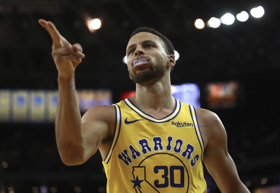 Golden State Warriors' Stephen Curry celebrates a score against the Washington Wizards during the second half of an NBA basketball game, Wednesday, Oct. 24, 2018, in Oakland, Calif. (AP Photo/Ben Margot)