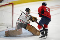 Washington Capitals right wing Garnet Hathaway (21) scores a goal against Chicago Blackhawks goaltender Marc-Andre Fleury (29) during the third period of an NHL hockey game, Thursday, Dec. 2, 2021, in Washington. The Blackhawks won 4-3 in a shootout. (AP Photo/Nick Wass)