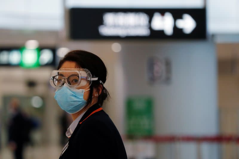 An employee wears goggles as she works at Hong Kong West Kowloon High Speed Train Station Terminus, before temporary closing, following the coronavirus outbreak in Hong Kong