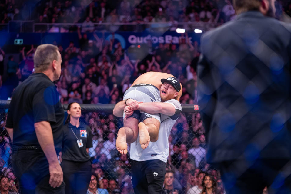 Coach Eric Nicksick hoists Sean Strickland in the air at UFC 293 on Saturday after Strickland defeated Israel Adesanya to win the middleweight title. (Courtesy Eric Nicksick)