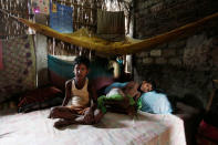 Sahil Shaikh (L) whose name is excluded from the draft list of the National Register of Citizens (NRC), poses for a picture with his cousin inside his house in Dhubri district, in the northeastern state of Assam, India August 3, 2018. REUTERS/Adnan Abidi