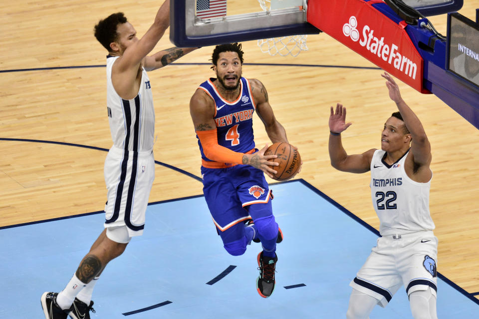 New York Knicks guard Derrick Rose (4) jumps to shoot between Memphis Grizzlies guard Desmond Bane (22) and forward Kyle Anderson in the second half of an NBA basketball game Monday, May 3, 2021, in Memphis, Tenn. (AP Photo/Brandon Dill)