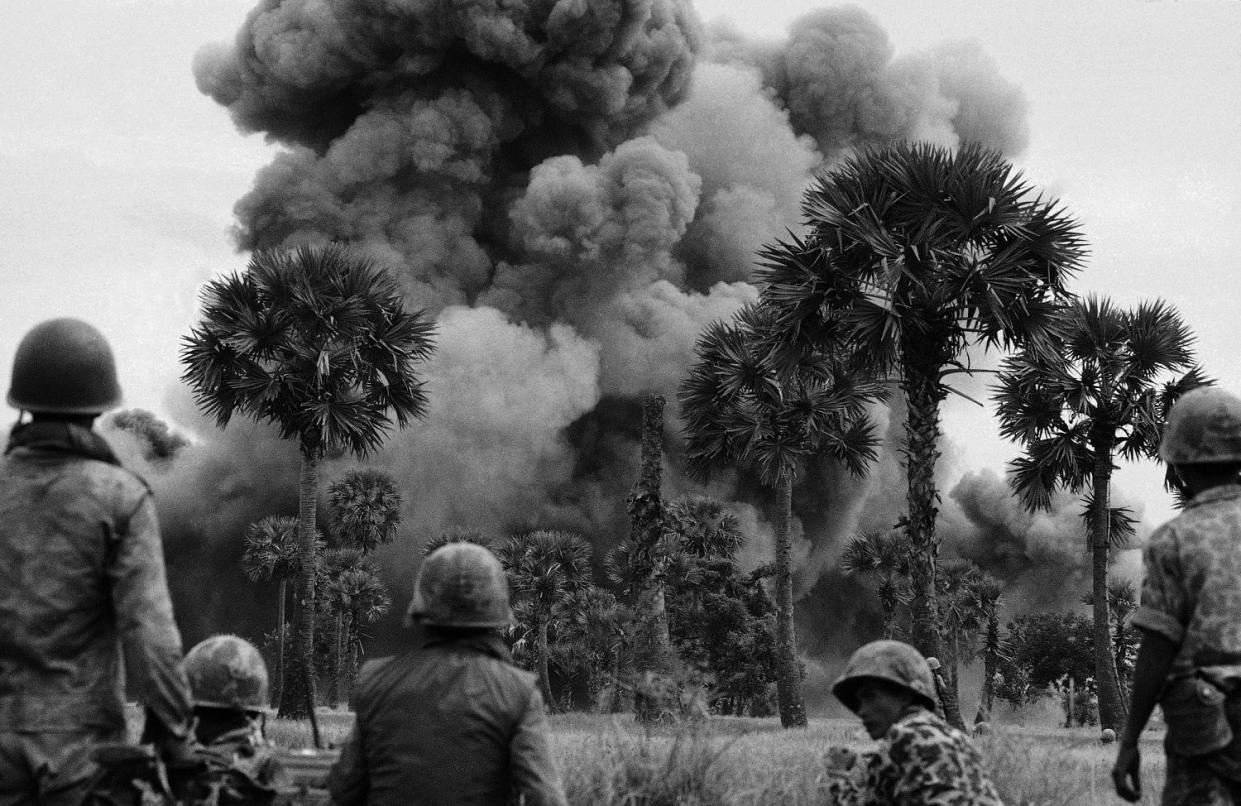 Smoke rises from bombs dropped by U.S. planes near the Cambodian capital of Phnom Penh on July 25, 1973, during Kissinger's tenure as National Security Adviser.  (AP file )