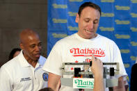 <p>Current men’s champion Joey Chestnut, right, of San Jose, Calif., watches the scale during his weigh-in for the 2017 Nathan’s Hot Dog Eating Contest, in Brooklyn Borough Hall, in New York, Monday, July 3, 2017. Looking on with him is Brooklyn Borough President Eric Adams. Chestnut weighed-in at 221.5 pounds. (AP Photo/Richard Drew) </p>