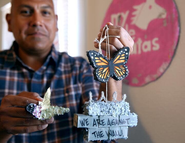 Isaias Rodriguez shows some of the mini pinatas he creates at his studio in Fresno, on Saturday, Oct. 8, 2022. Rodriguez is a third-generation Chicano originally from Boyle Heights and is eighth of 11 children. His work will be displayed in San Diego in late October.