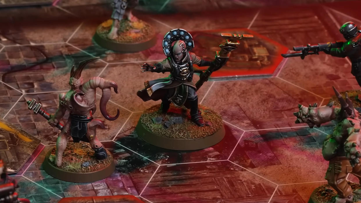  Models laid out on a board from Darktide: The Miniatures Game. 