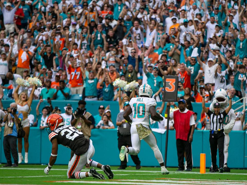 Miami Dolphins wide receiver Tyreek Hill (10), scores a touchdown late in the fourth quarter in front of Cleveland Browns cornerback Greg Newsome II (20) Cleveland Browns during NFL action Sunday November 13, 2022 at Hard Rock Stadium in Miami Gardens.