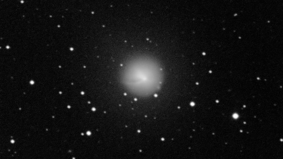 A large white circular cloud of gas around a comet after an eruption