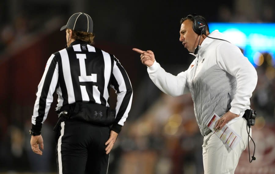 Texas head coach Steve Sarkisian, right, disputes a timeout with an official, left, during the first half of an NCAA college football game against Iowa State, Saturday, Nov. 18, 2023, in Ames, Iowa. (AP Photo/Matthew Putney)