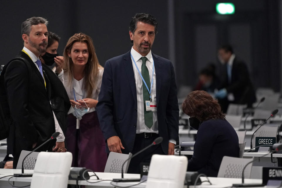 Joaquim Alvaro Pereira Leite, Brazil's Minister of the Environment gets to his feet after a plenary session during an interview at the COP26 U.N. Climate Summit in Glasgow, Scotland, Friday, Nov. 12, 2021. (AP Photo/Alberto Pezzali)