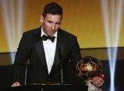 FC Barcelona's Lionel Messi of Argentina holds the World Player of the Year award during the FIFA Ballon d'Or 2015 ceremony in Zurich, Switzerland, January 11, 2016. REUTERS/Arnd Wiegmann
