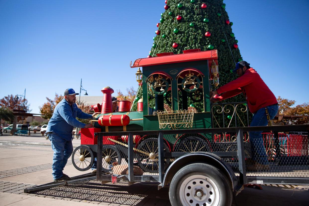 City employees set up holiday decorations on Tuesday, Nov. 29, 2022, at the plaza in downtown Las Cruces. 