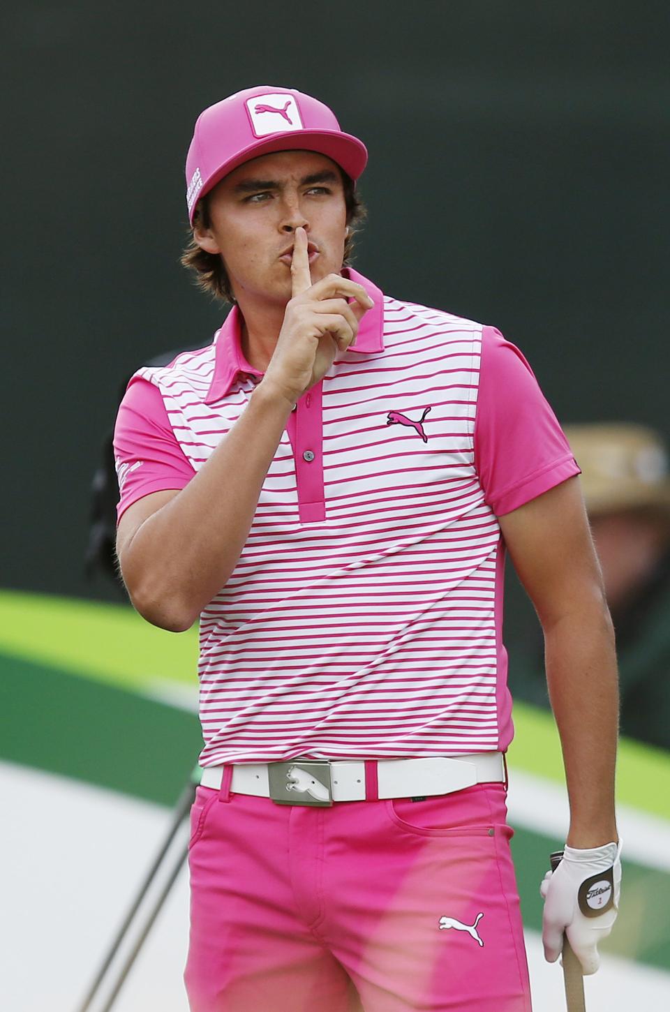 Rickie Fowler teases the crowd to be quiet as he steps onto the 16th tee box during the second round of the Phoenix Open golf tournament on Friday, Jan. 31, 2014, in Scottsdale, Ariz. (AP Photo/Ross D. Franklin)