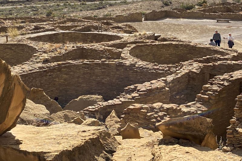 Tourists view Pueblo Bonito, one of a series of Puebloan structures in Chaco Canyon