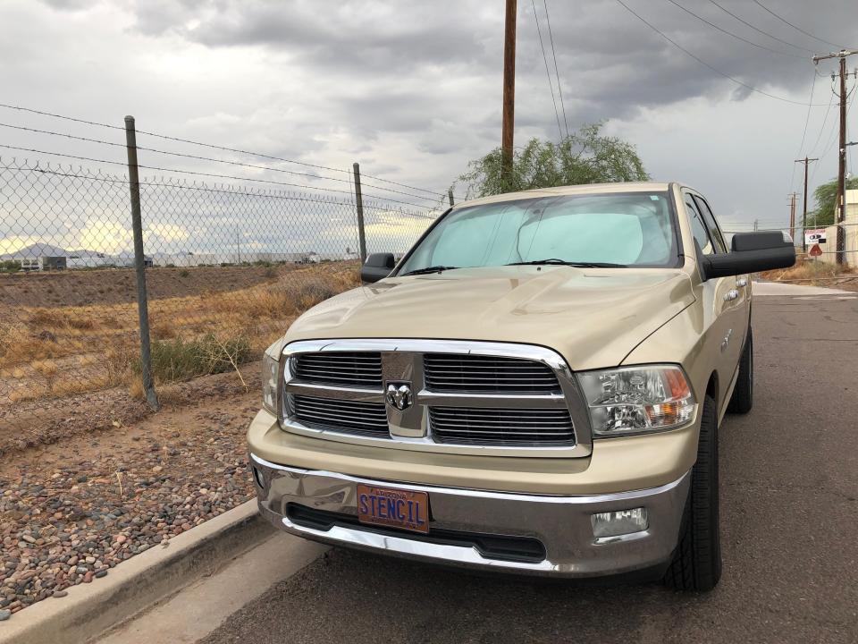 The vehicle of former priest Steven Stencil, left, is parked outside a bus company in Phoenix, Ariz., on Thursday, Sept. 26, 2019. In 2001, Stencil was suspended from ministry after a trip to Mexico that violated a Diocese of Tucson policy forbidding clerics from being with minors overnight. Since 2003, his name has appeared on the diocese's list of clerics credibly accused of sexually abusing children, and his request to leave the priesthood was granted in 2011. In a 2019 Facebook post, the former priest said that he was working as a driver for this private bus company that specializes in educational tours for school groups and scout troops. (AP Photo/Anita Snow)