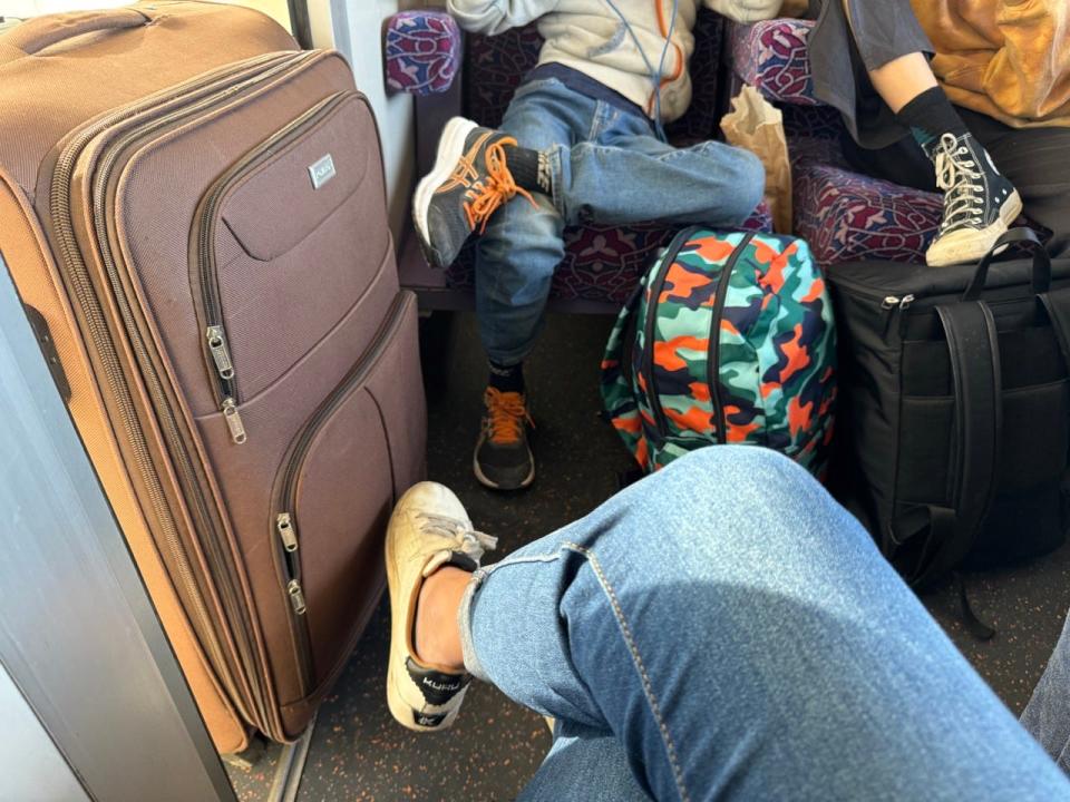 bags stuffed in first-class train car