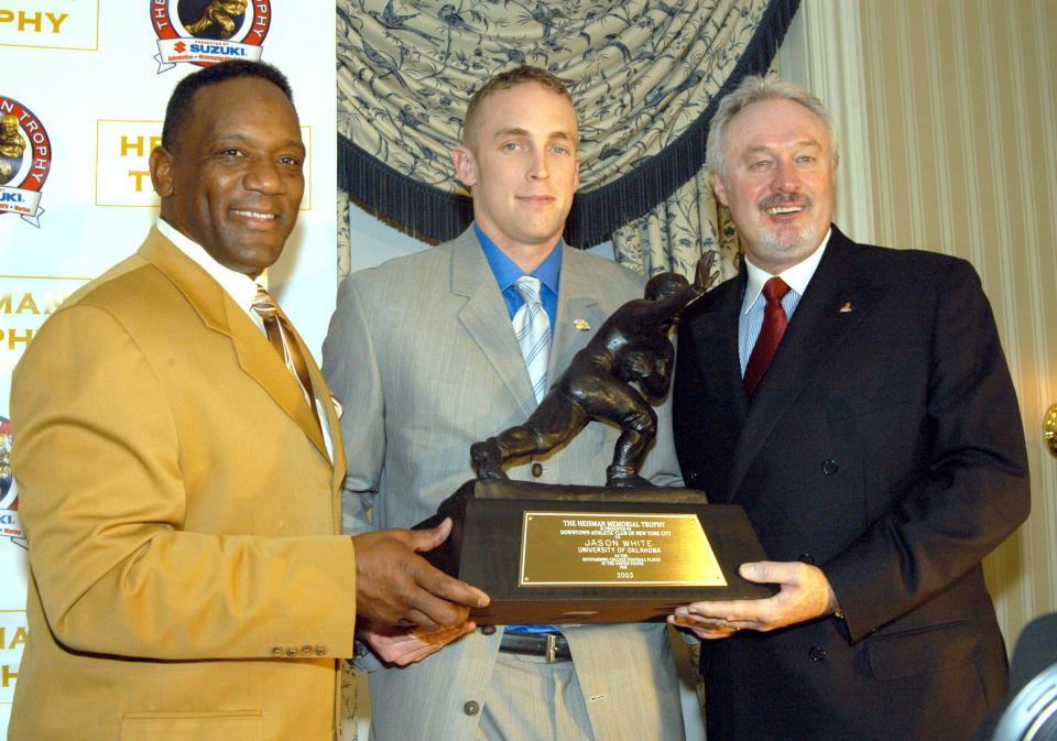 Owens (R) with Billy Sims (L) and Jason White. (Getty Images)