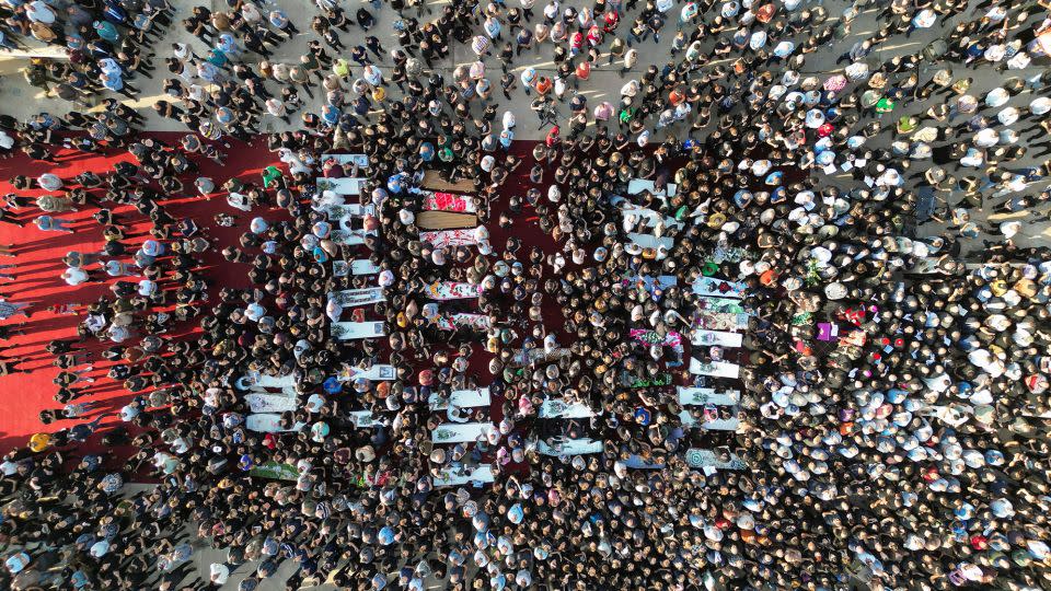 People attend funerals in Hamdanya, Iraq, on Wednesday. - Abdullah Rashid/Reuters