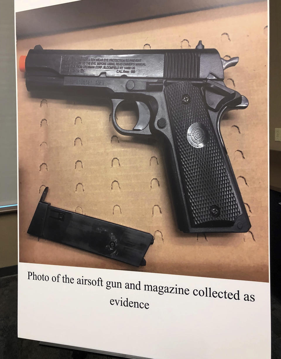 An evidence photo of what Tempe, Ariz., police say is the replica handgun recovered from a boy who was shot by an officer is displayed at a news conference in Tempe Friday, Jan. 18, 2019. Police Chief Sylvia Moir offered her condolences to the family of a 14-year-old burglary suspect who was shot and killed by an officer, calling the boy's death "tragic" but asking that the public withhold judgment until an investigation is completed. (AP Photo/Anita Snow)