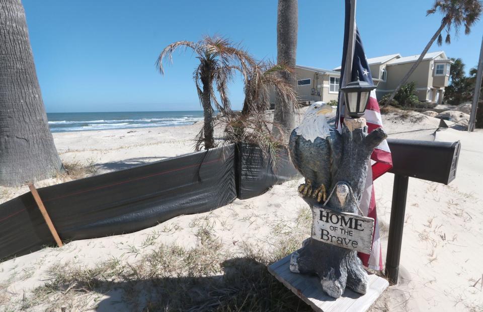 A patriotic mailbox post and American flag are all that's left of a home demolished by its owner at 4115 S, Atlantic Ave. in hard-hit Wilbur-by-the-Sea. A year after Tropical Storm Nicole, its impact is still being felt by many homeowners and business owners in Volusia and Flagler counties. .