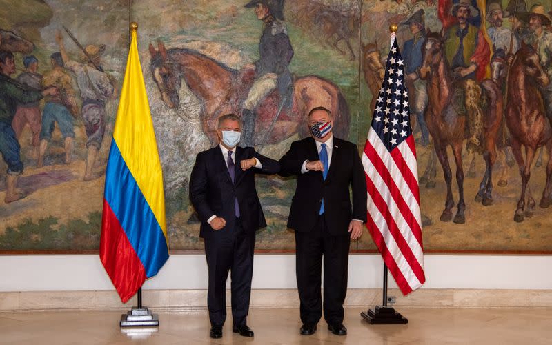 Colombian President Ivan Duque Marquez and U.S. Secretary of State Mike Pompeo bump elbows before attending a meeting at the presidential house in Bogota