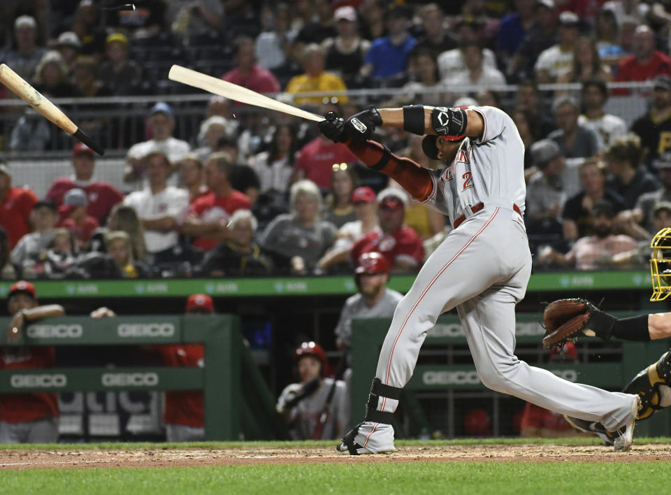 Cincinnati Reds' Austin Romine (2) fouls the ball and breaks his bat on a pitch thrown by Pittsburgh Pirates reliever Yohan during the eighth inning of a baseball game, Saturday, Aug. 20, 2022, in Pittsburgh. (AP Photo/Philip G. Pavely)