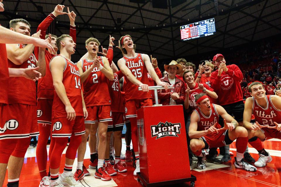 Utah Utes celebrate their victory over rival Brigham Young University during a men’s basketball game at the Jon M. Huntsman Center in Salt Lake City on Saturday, Dec. 9, 2023.