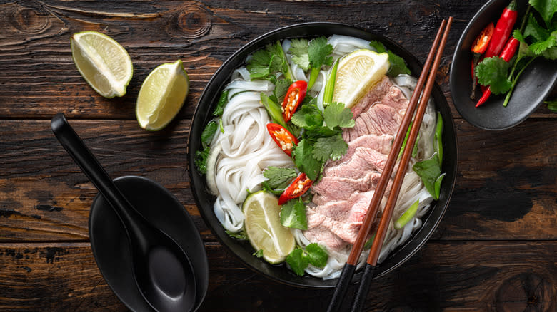 Bowl of pho with garnishes