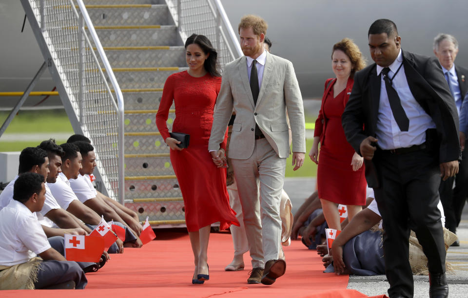 Britain's Prince Harry and Meghan, Duchess of Sussex arrive at Fua'amotu Airport in Nuku'alofa,Tonga, Thursday, Oct. 25, 2018. Prince Harry and his wife Meghan are on day 10 of their 16-day tour of Australia and the South Pacific. (AP Photo/Kirsty Wigglesworth)