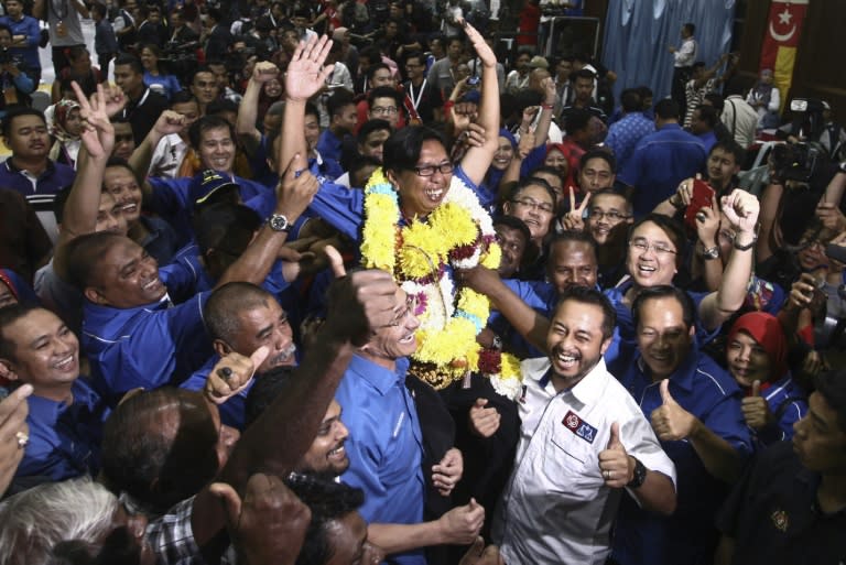 Supporters of the United Malays National Organisation (UMNO) hoist Budiman Mohamad Zohdi after he won a by-election in Sungai Besar, a coastal town outside Kuala Lumpur on June 18, 2016