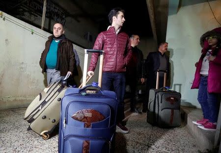 Fuad Sharef, an Iraqi with an immigration visa who was prevented with his family from boarding a flight to New York a week ago,carry bags in Erbil, the capital of the Kurdish region in northern Iraq February 4, 2017, before going to the airport to fly, on Turkish Airlines, to Nashville, Tennessee, their new home. REUTERS/Ahmed Saad