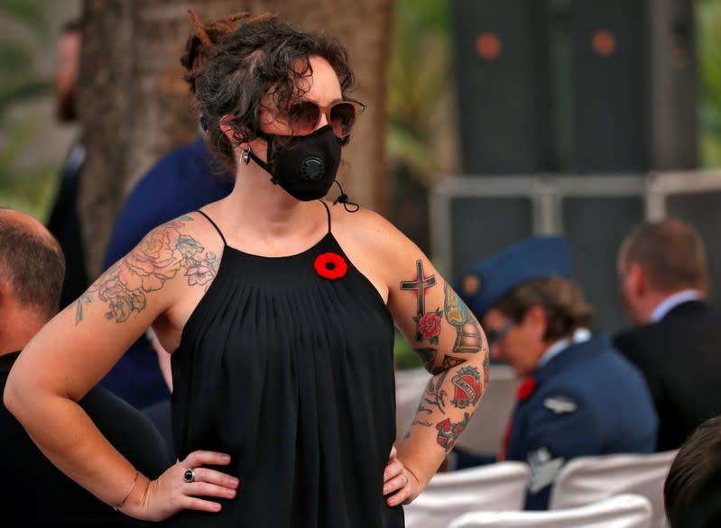 An attendee wearing protective mask is seen at Delhi War Cemetery before Britain's Prince Charles' visit to the cemetery in New Delhi