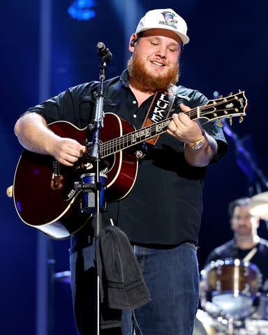 <p>Jason Kempin/Getty</p> Luke Combs performs in Nashville in June 2023