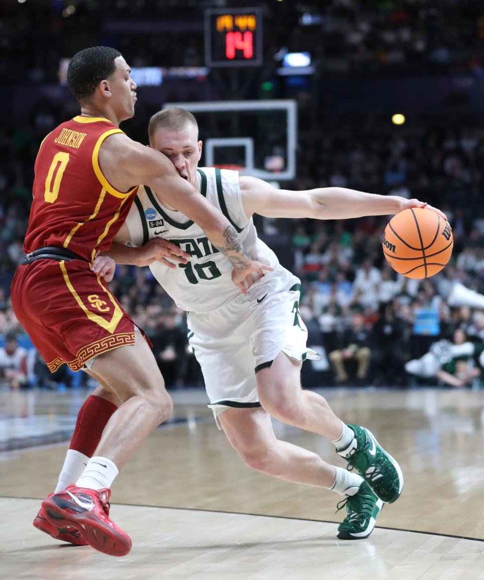 Michigan State Spartans forward Joey Hauser drives against USC Trojans forward Kobe Johnson during the NCAA tournament first round Friday, March 17, 2023 in Columbus, Ohio.