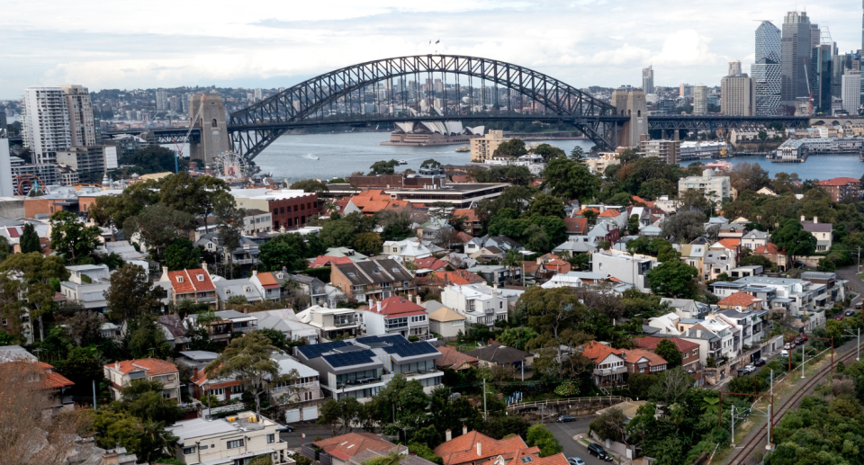 Sydney property market, aerial view of houses, Harbour Bridge. Buying property and stamp duty tax concept.