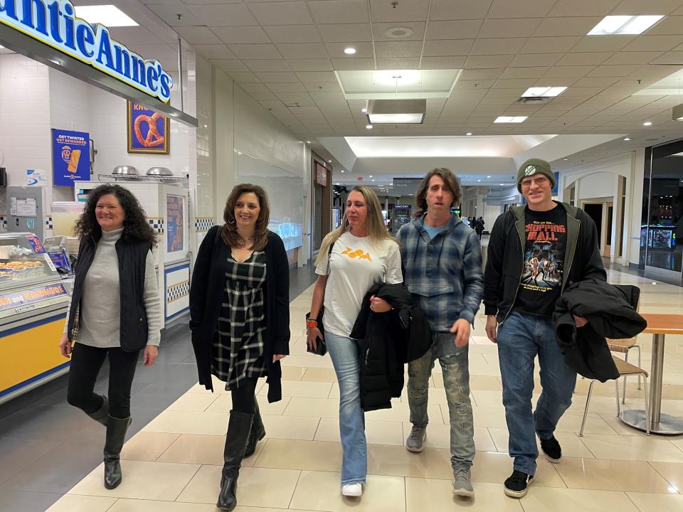 From left, Pamela Herzenberg, Maria Ciaramella, Rachel Albany, Charlie Leonard and John Keller walk through Monmouth Mall on Jan. 23, 2024. All five are members of Leonard's Facebook group Monmouth Mall Memories.