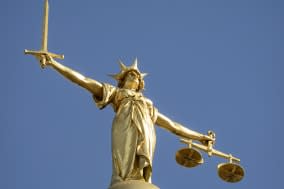 Close-up of the statue of Lady Justice, holding a sword and the scales of justice, located on top of the dome above the Old Bail