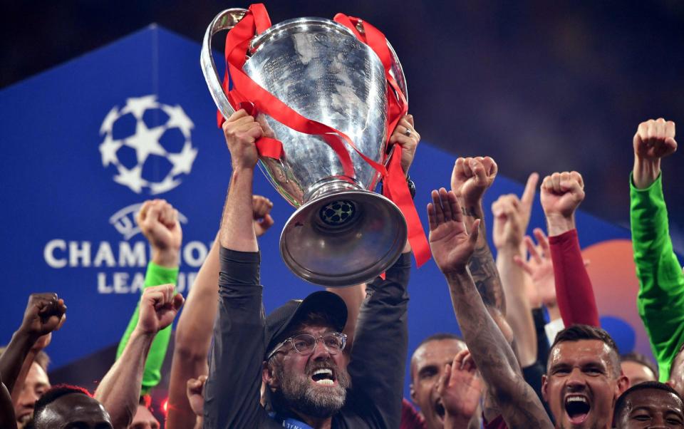 In this file photo taken on June 1, 2019 Liverpool's German manager Jurgen Klopp (C) raises the trophy after winning the UEFA Champions League final football match between Liverpool and Tottenham Hotspur at the Wanda Metropolitano Stadium in Madrid - AFP via Getty Images