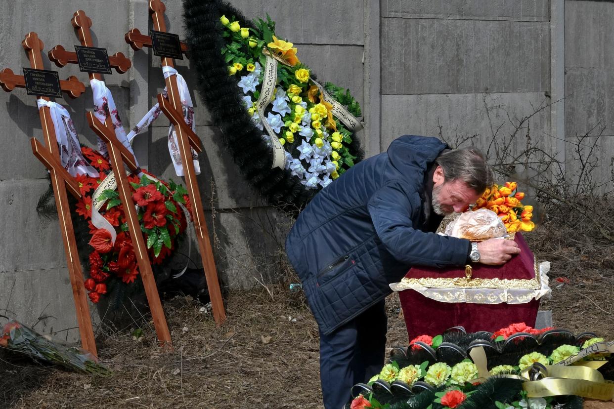 March 30, 2022: A relative mourns on the coffin with the body of 3 year-old Mykola Goryainiv, who died with his parents as they were driving a car trying to evacuate from a fighting zone in Kharkiv region, during a funeral ceremony in Kramatorsk, Ukraine.